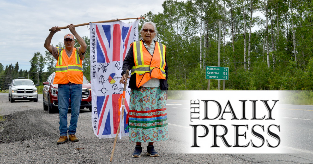 Still strong and dedicated, Elder Angela Ashishkeesh, of Attawapiskat First Nation, participates in a protest walk against Ontario’s Bill 5 and Canada’s Bill C-5. She is pictured here with flag bearer Rick Cheechoo, of Moose Cree First Nation. XAVIER KATAQUAPLIT/FOR THE DAILY PRESS