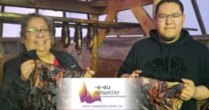The traditional custom of making Nah-Mesh-Tek, smoked goose is a practise that has been handed down for generations in Attawapiskat First Nation on the James Bay coast. Here we see Janie Wesley with her nephew Orion Kataquapit as they hold up their latest batch of Nah-Mesh-Tek, smoked goose. Photo by Brian Wesley.