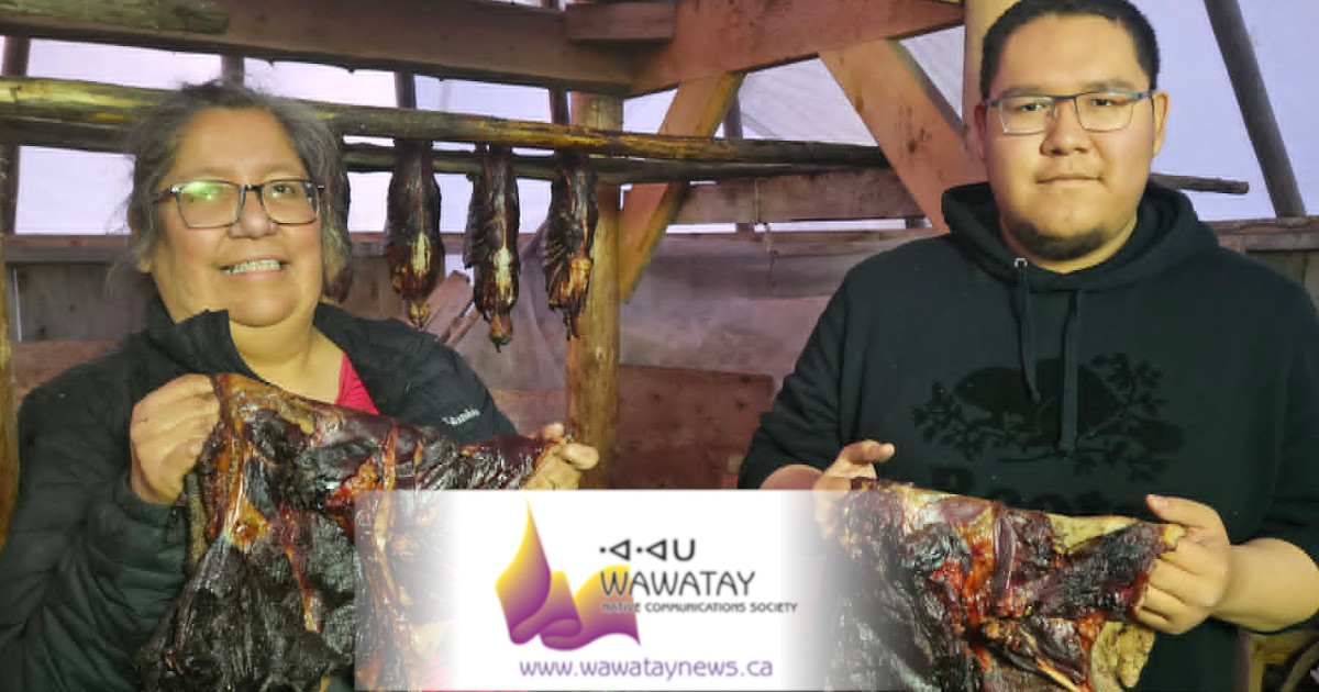 The traditional custom of making Nah-Mesh-Tek, smoked goose is a practise that has been handed down for generations in Attawapiskat First Nation on the James Bay coast. Here we see Janie Wesley with her nephew Orion Kataquapit as they hold up their latest batch of Nah-Mesh-Tek, smoked goose. Photo by Brian Wesley.